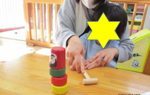 写真：だるま落としをしている子ども